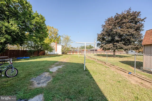 a view of yard with swimming pool and sitting area