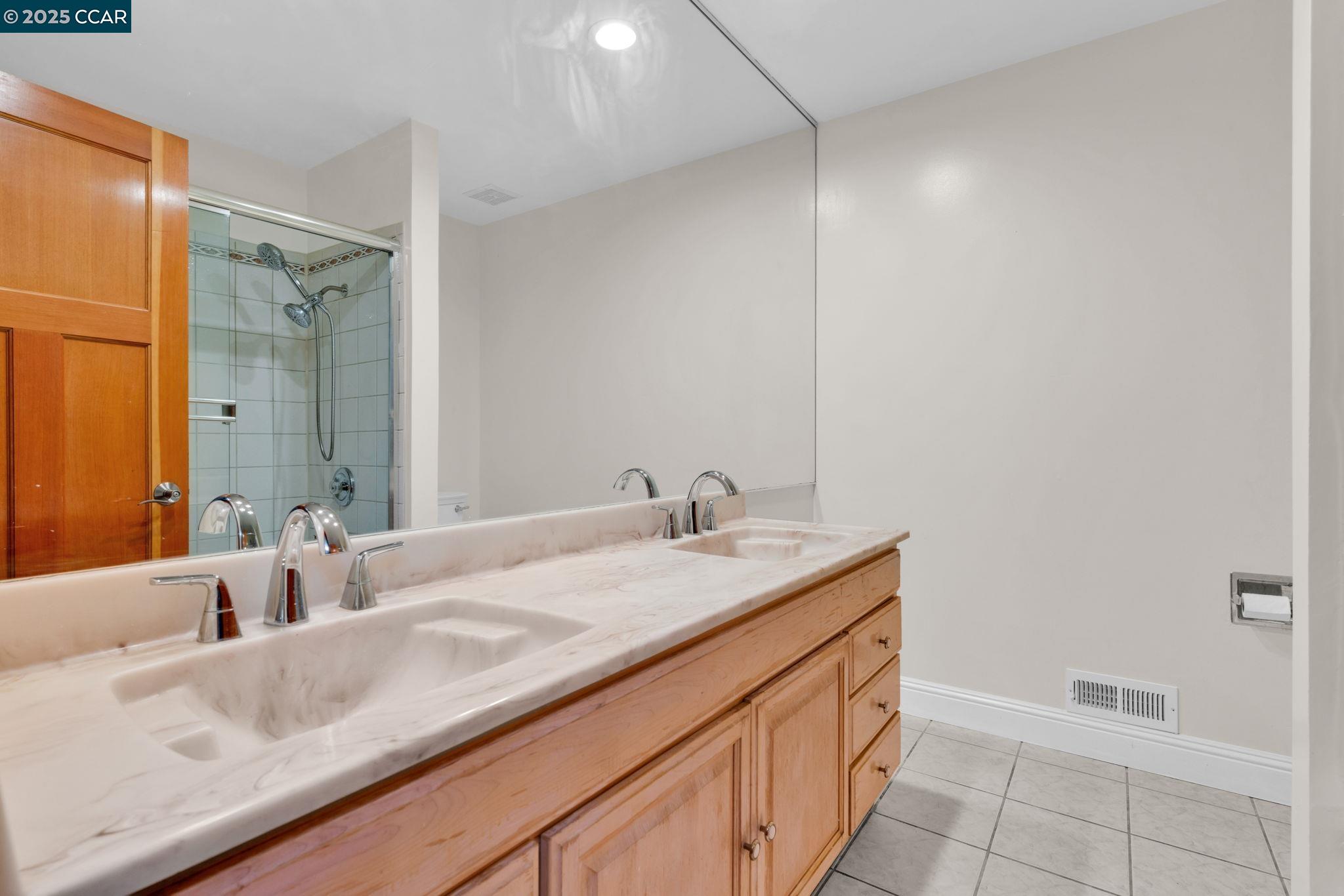 920 Palmer Road Walnut Creek, CA 94596 - Photo 23 of 47 a bathroom with a granite countertop sink and a mirror