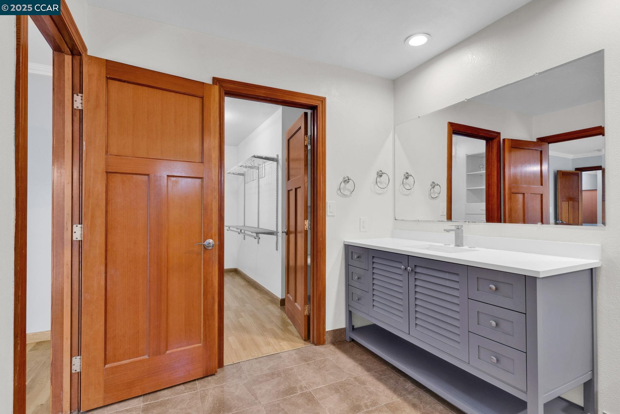 920 Palmer Road Walnut Creek, CA 94596 - Photo 25 of 47 a spacious bathroom with a granite countertop sink and a mirror
