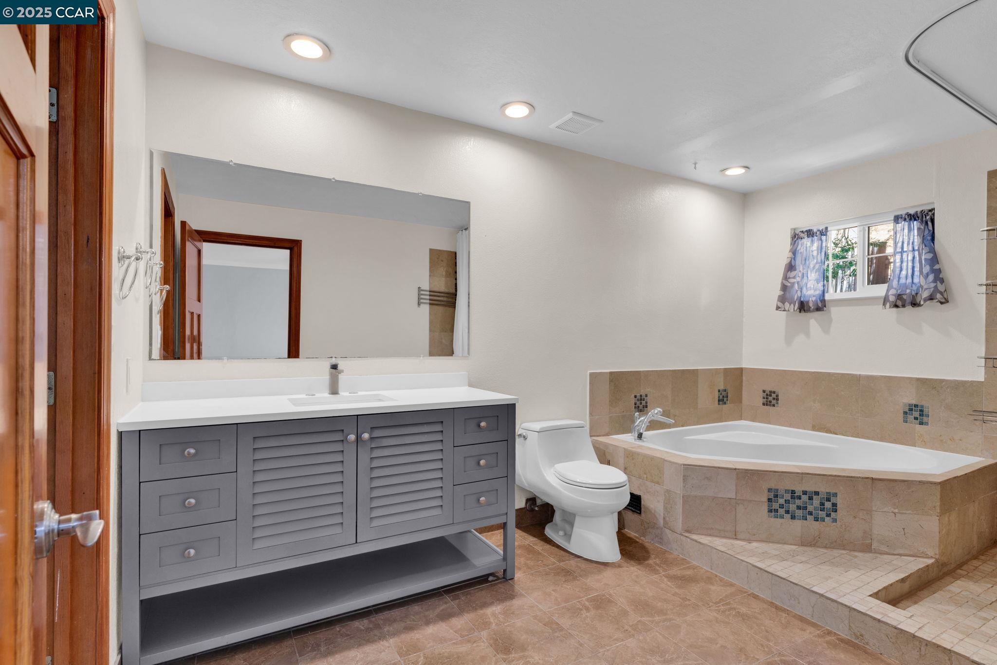 920 Palmer Road Walnut Creek, CA 94596 - Photo 29 of 47 a spacious bathroom with a tub sink and mirror
