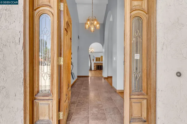 a view of a bathroom with windows and chandelier