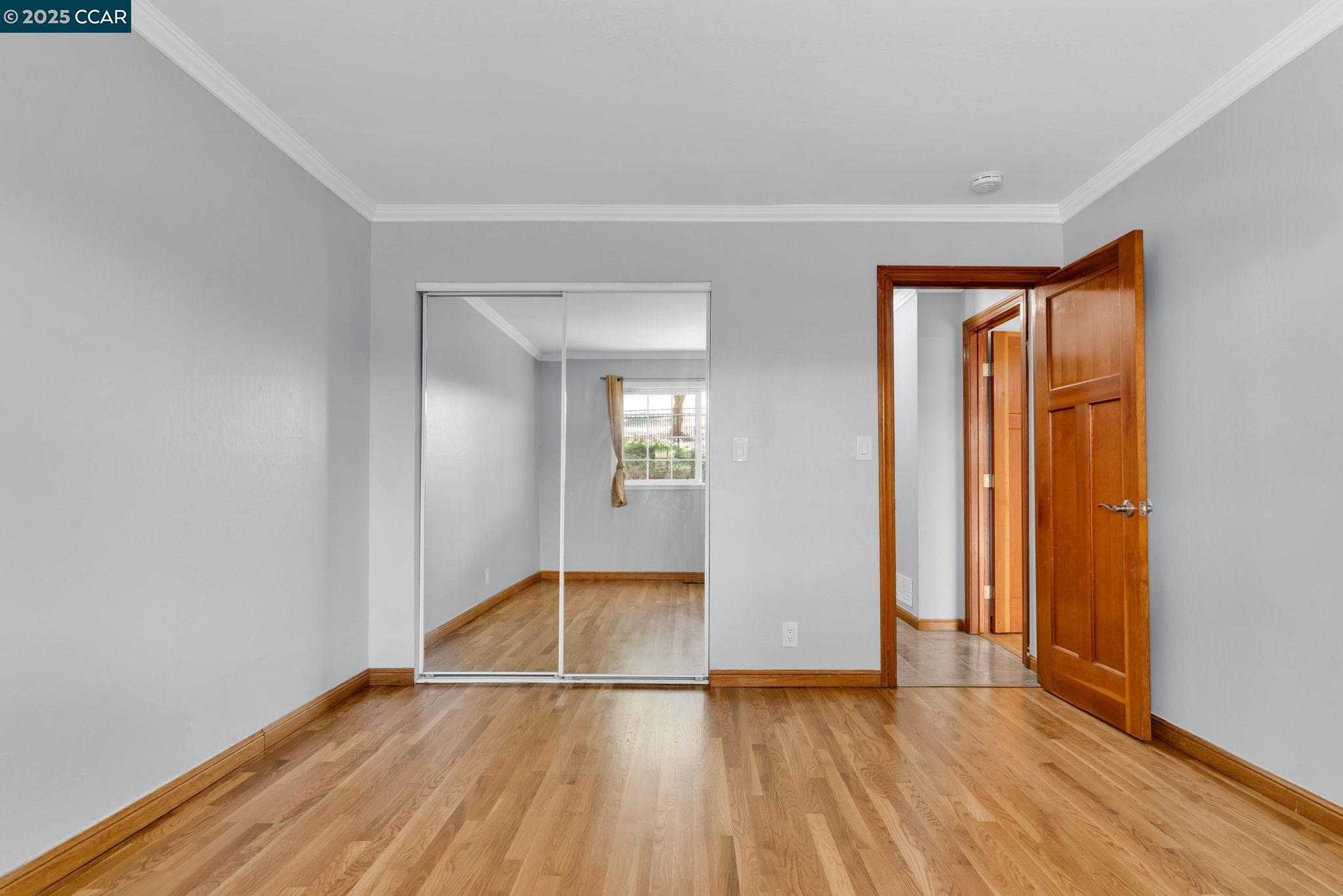 920 Palmer Road Walnut Creek, CA 94596 - Photo 31 of 47 an empty room with wooden floor and glass door