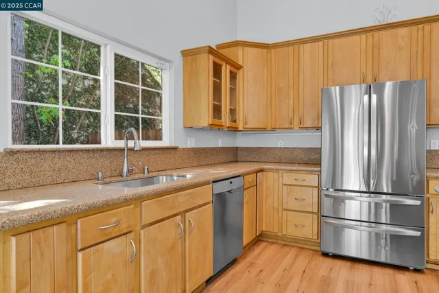 a kitchen with appliances cabinets and a sink