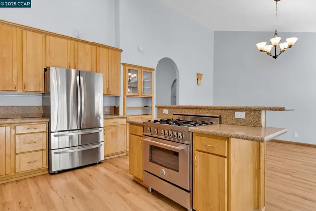 a kitchen with a stove a sink and a refrigerator