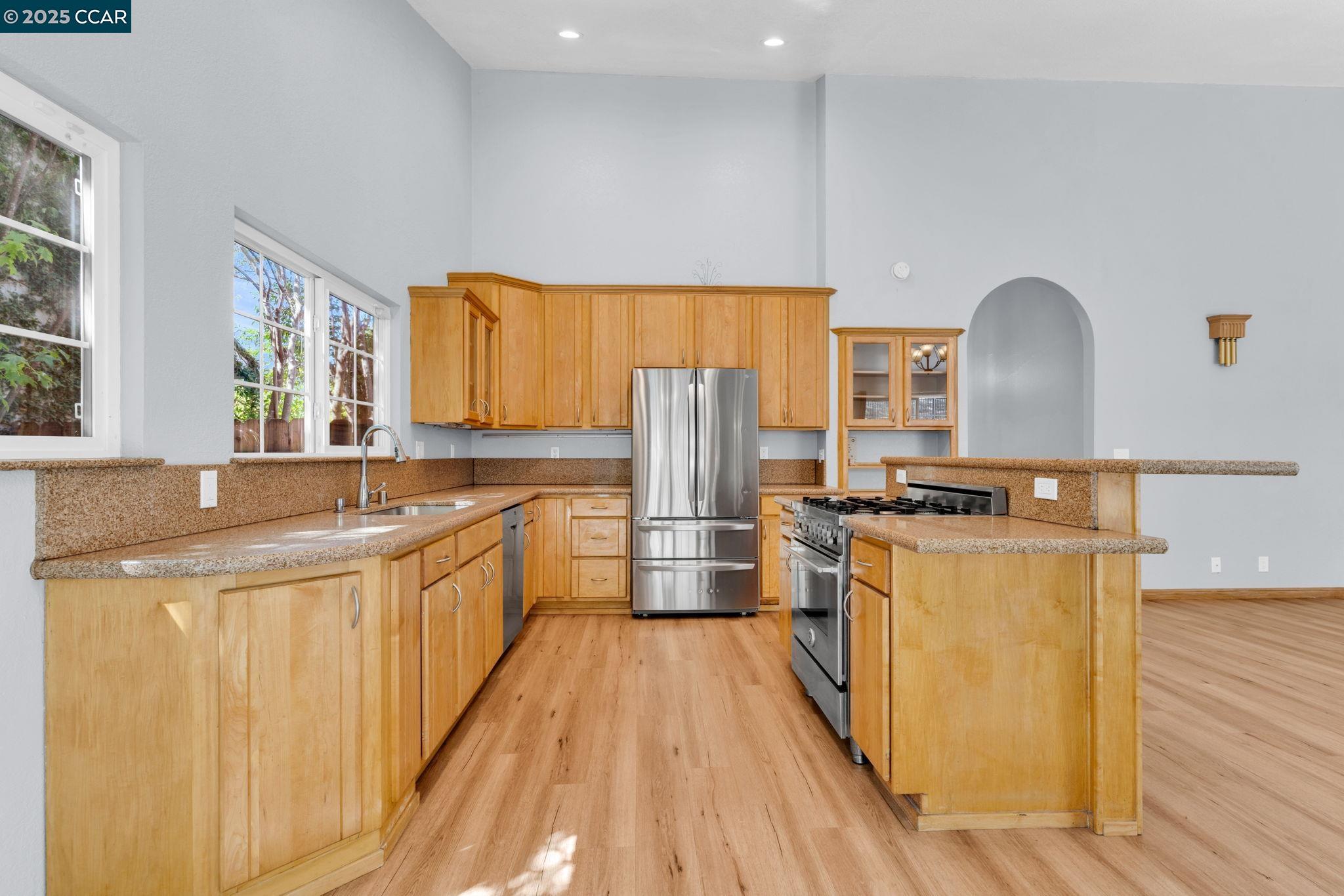 920 Palmer Road Walnut Creek, CA 94596 - Photo 9 of 47 a kitchen with stainless steel appliances granite countertop a stove a sink dishwasher a refrigerator and wooden cabinets with wooden floor