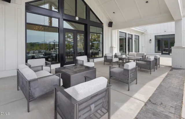 a living room with furniture a dining table and a fireplace