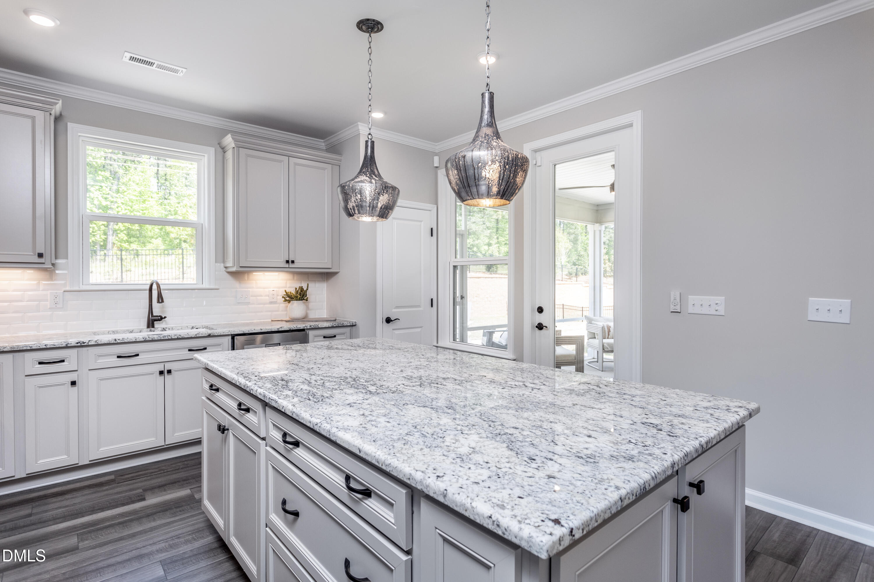 35 Rockingham Way Clayton, NC 27520 - Photo 3 of 42 a kitchen with stainless steel appliances granite countertop stove a sink a center island and windows