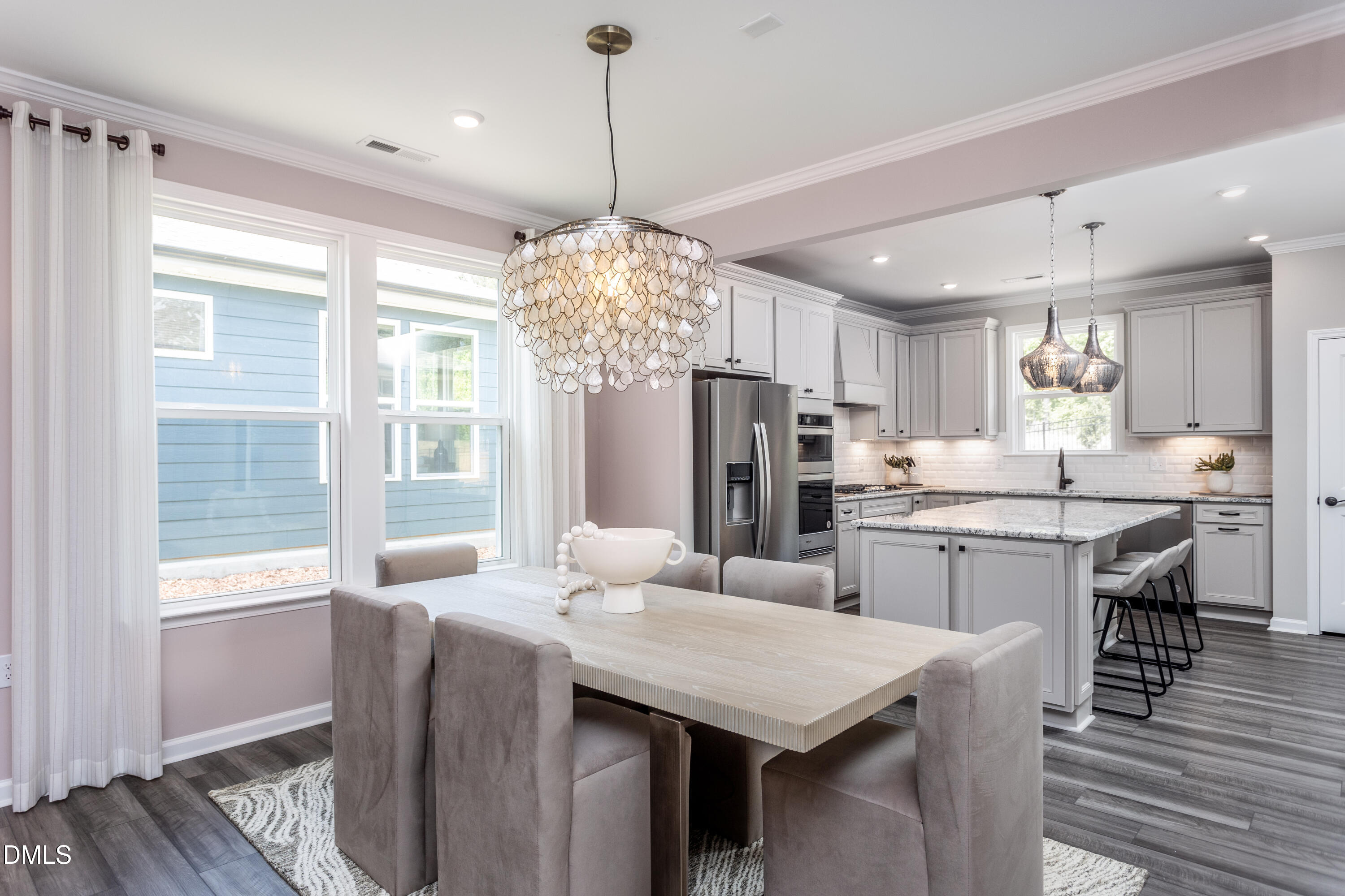 35 Rockingham Way Clayton, NC 27520 - Photo 7 of 42 a kitchen with stainless steel appliances a dining table chairs and wooden floor