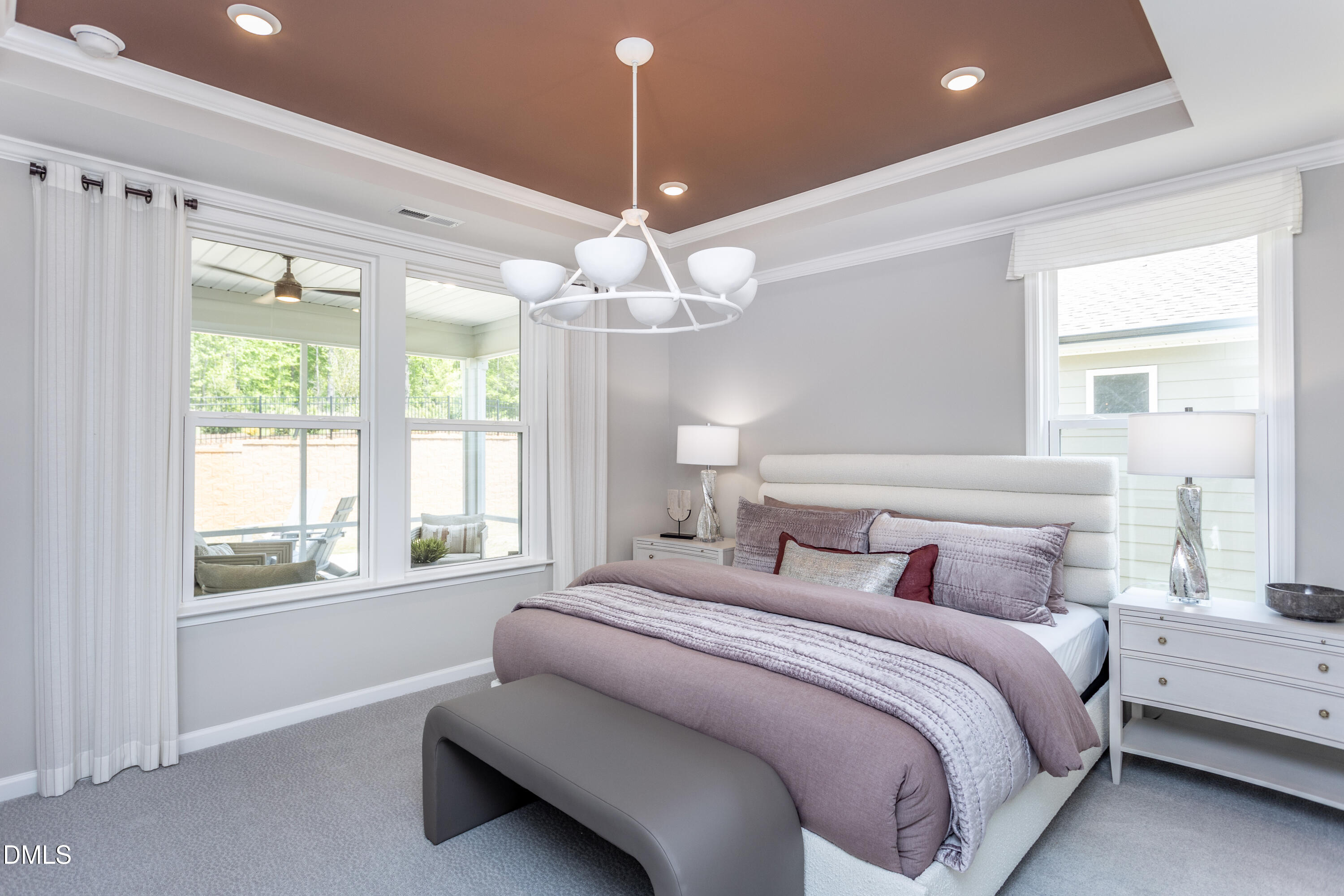 35 Rockingham Way Clayton, NC 27520 - Photo 8 of 42 a bedroom with a large bed and a chandelier