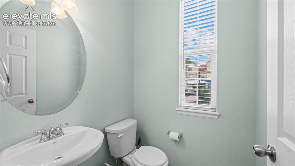4023 Diamond Ridge View Colorado Springs, CO 80918 - Photo 14 of 31 a bathroom with a toilet sink and mirror