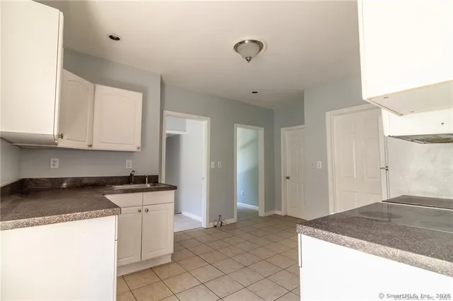 a kitchen with stainless steel appliances granite countertop a sink and cabinets