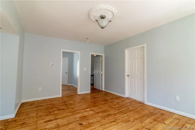 a view of a room with wooden floor