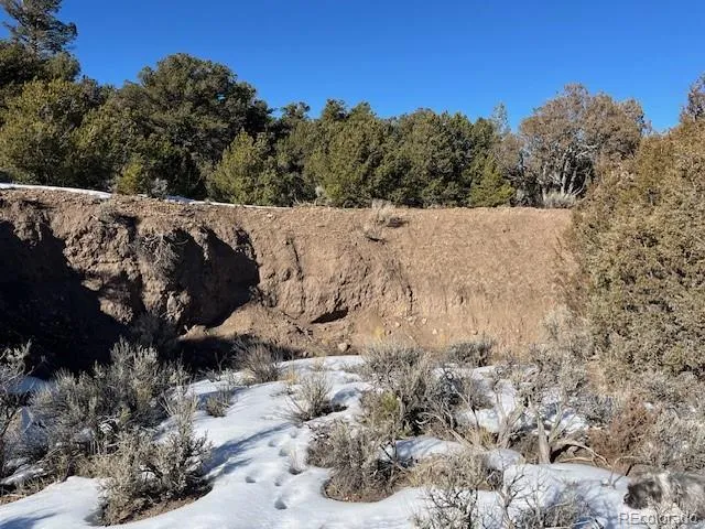a view of a road with a snow in the background