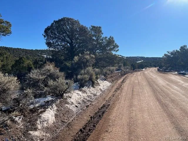 a view of a large mountain with mountains in the background