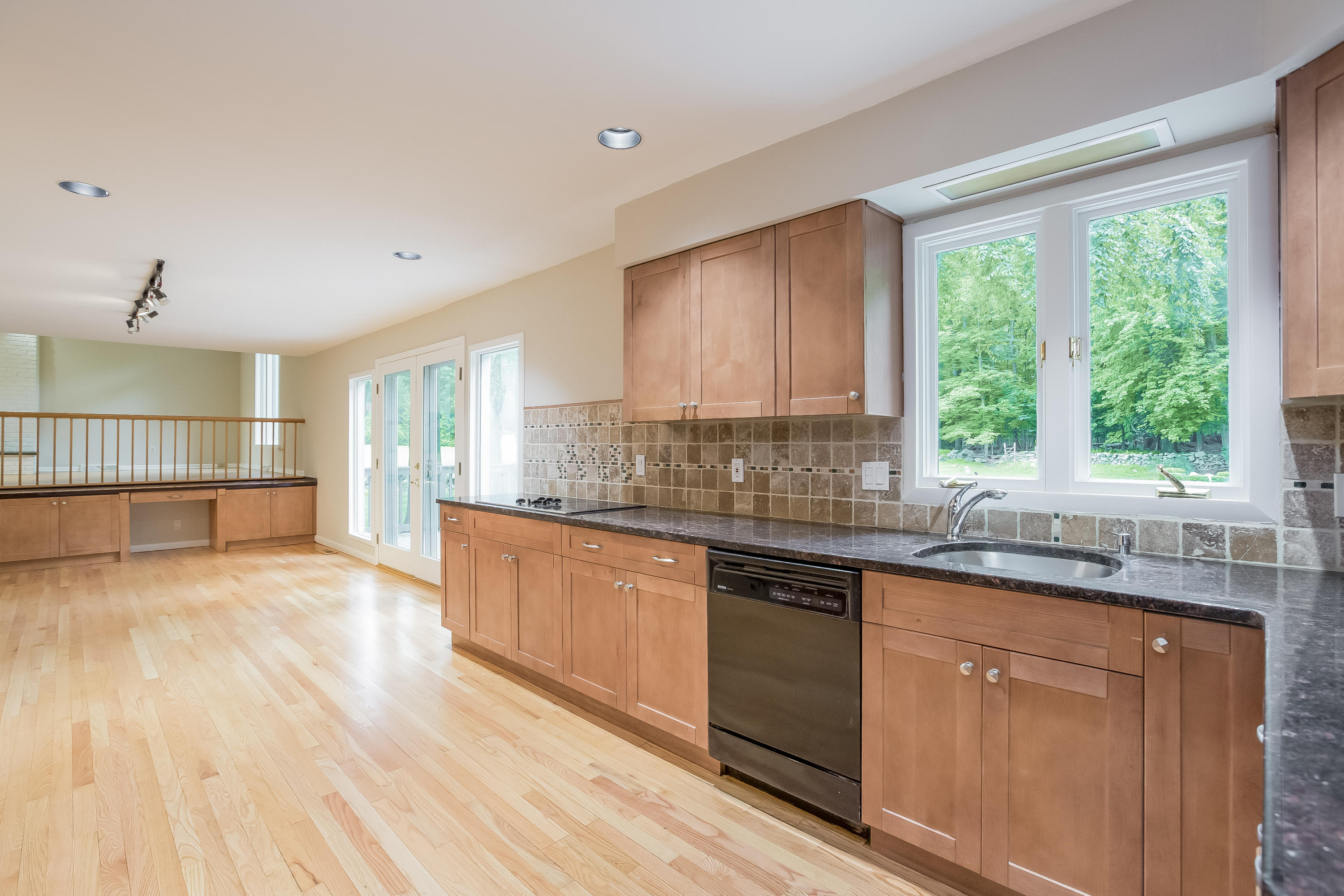 92 Rolling Ridge Road Stamford, CT 06903 - Photo 12 of 34 a large kitchen with granite countertop a stove a sink wooden floor white cabinets and a window