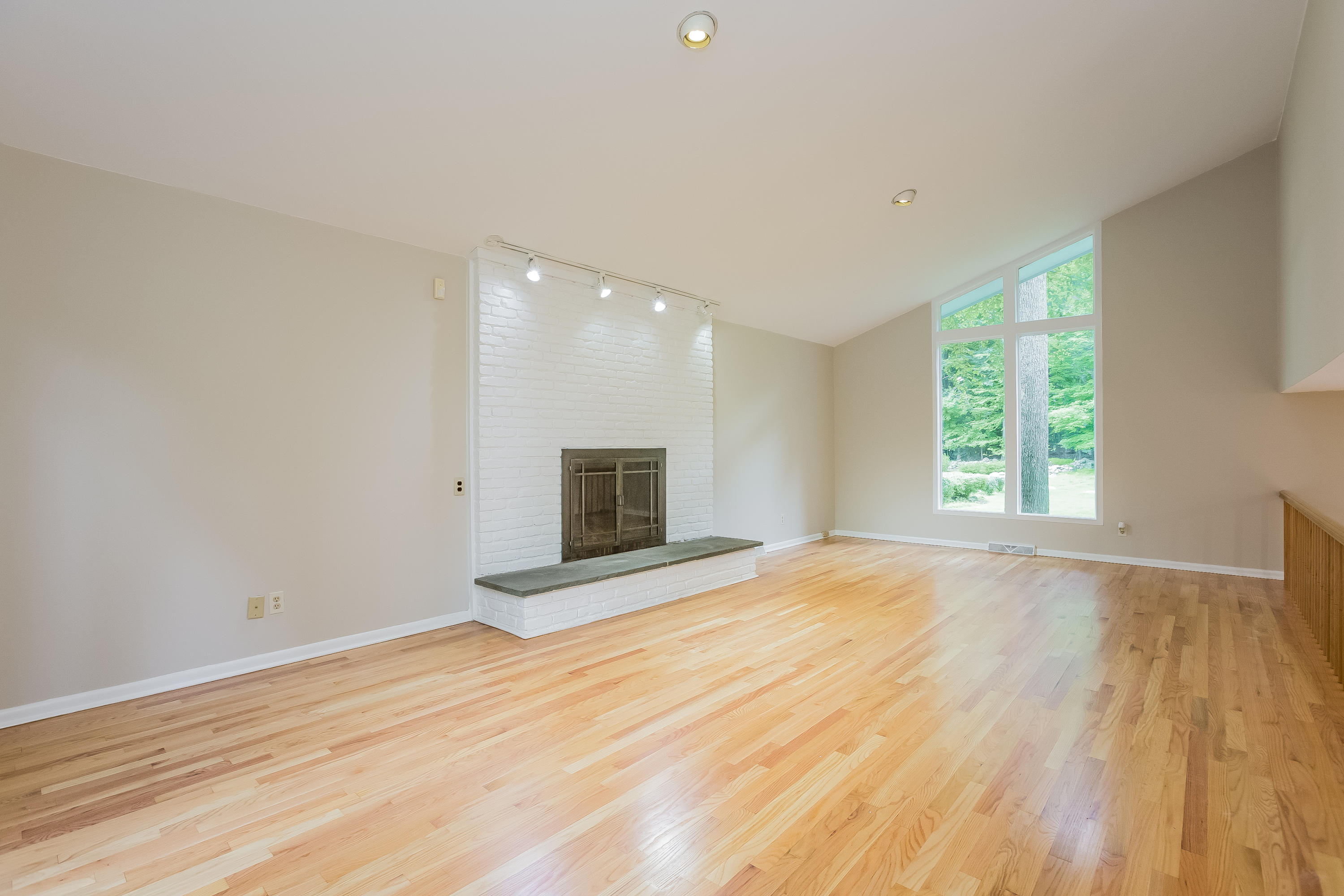 92 Rolling Ridge Road Stamford, CT 06903 - Photo 15 of 34 a view of an empty room with wooden floor and a window