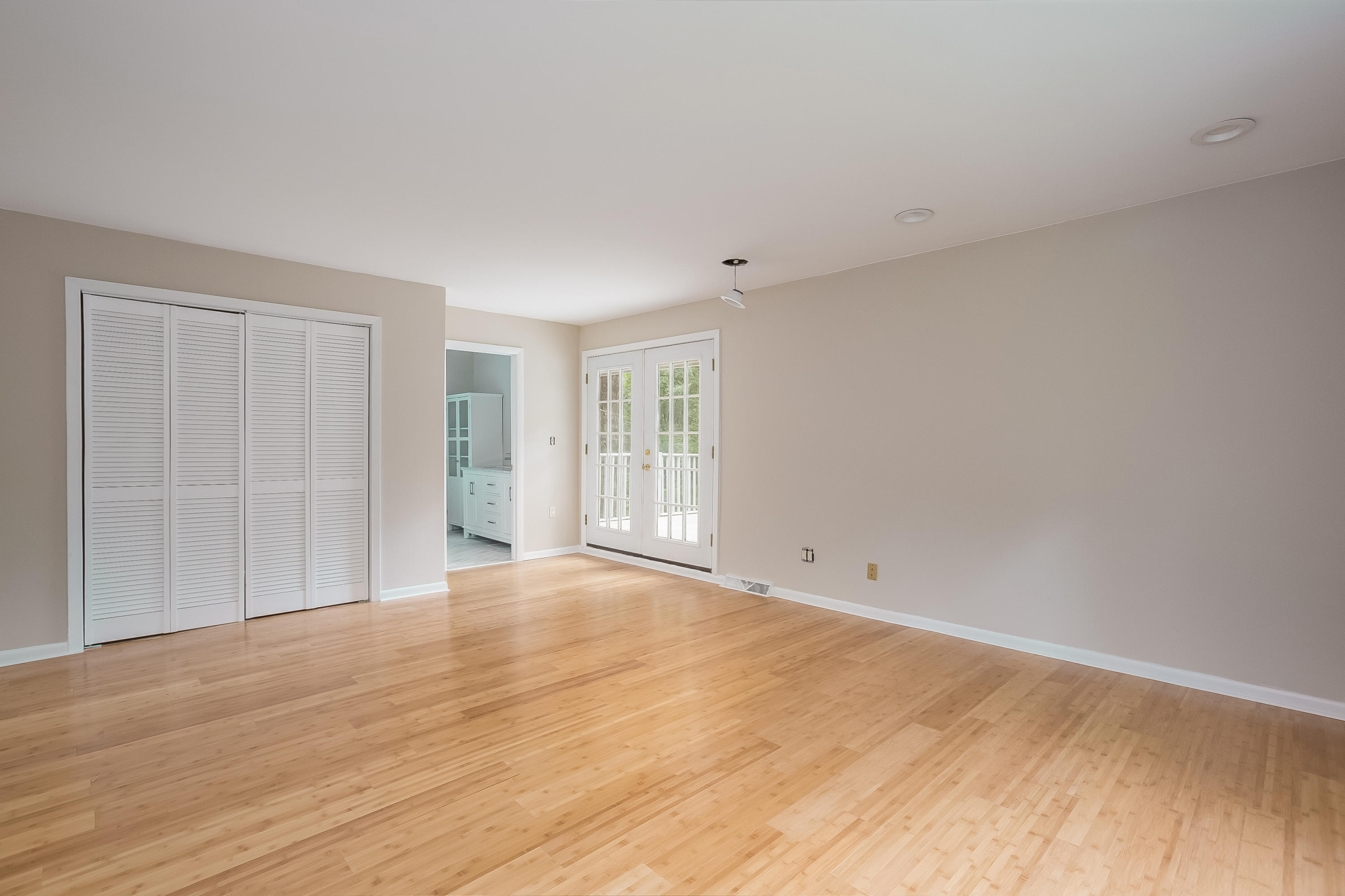 92 Rolling Ridge Road Stamford, CT 06903 - Photo 20 of 34 a view of an empty room with wooden floor and a window