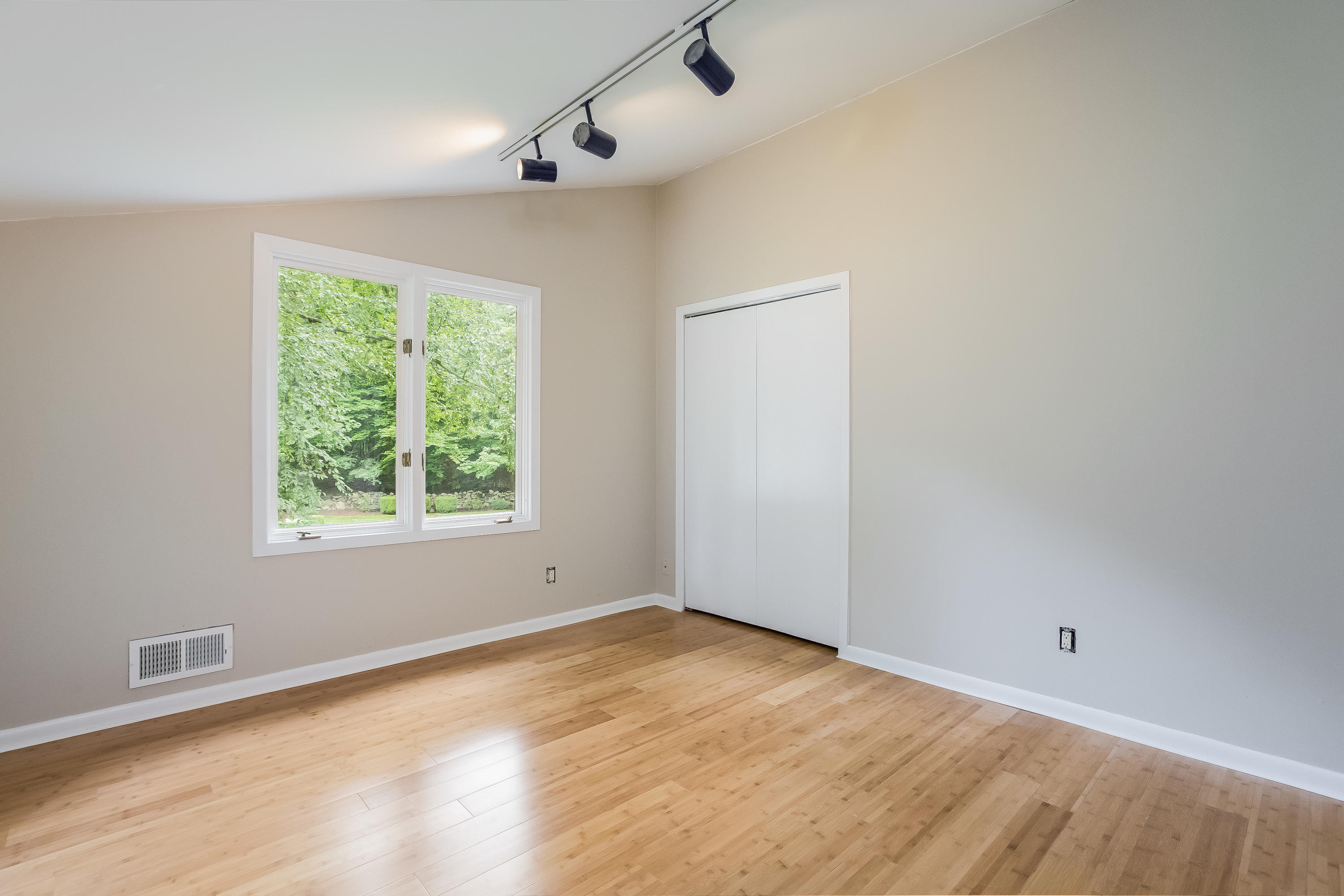 92 Rolling Ridge Road Stamford, CT 06903 - Photo 23 of 34 an empty room with wooden floor and windows