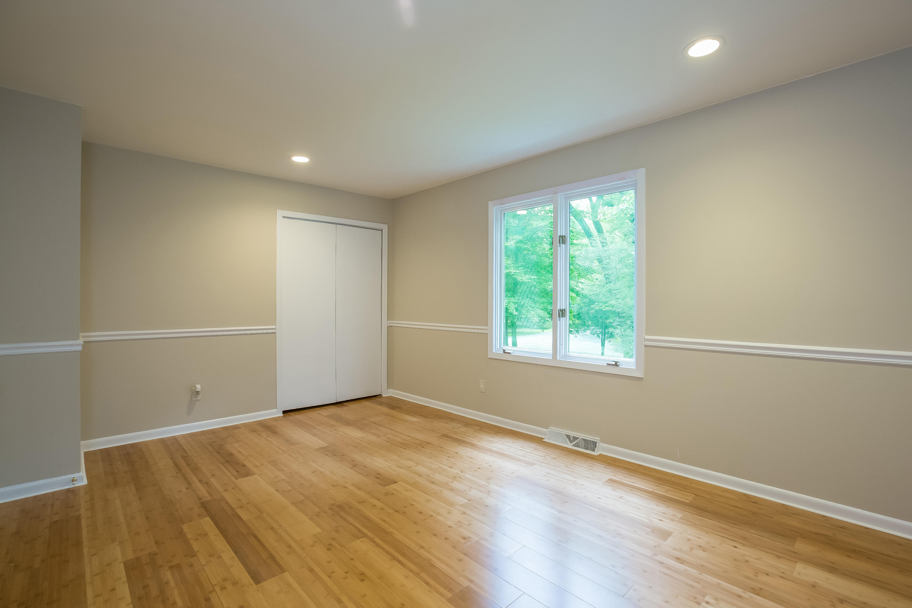 92 Rolling Ridge Road Stamford, CT 06903 - Photo 24 of 34 an empty room with wooden floor and windows
