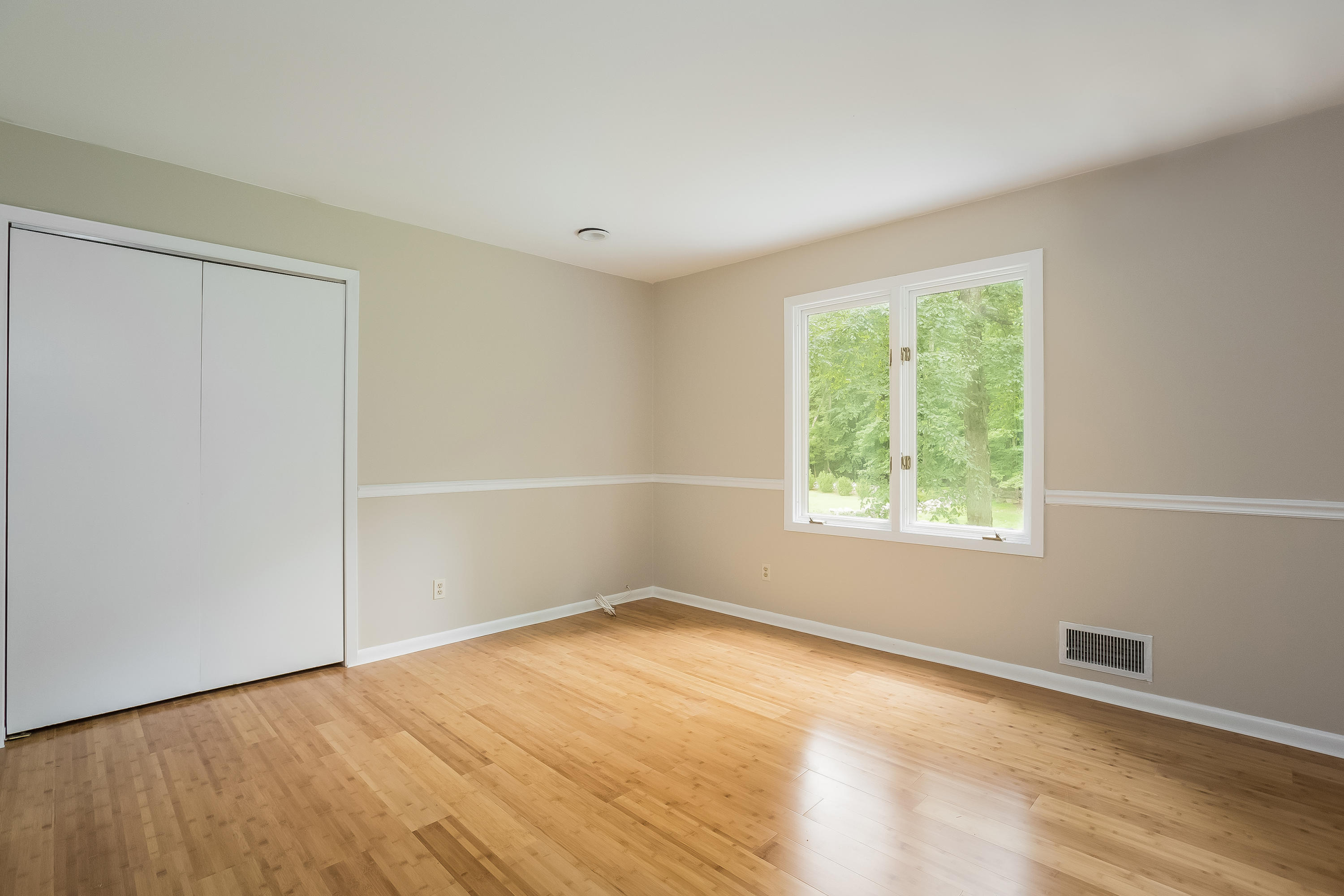 92 Rolling Ridge Road Stamford, CT 06903 - Photo 25 of 34 an empty room with wooden floor and windows