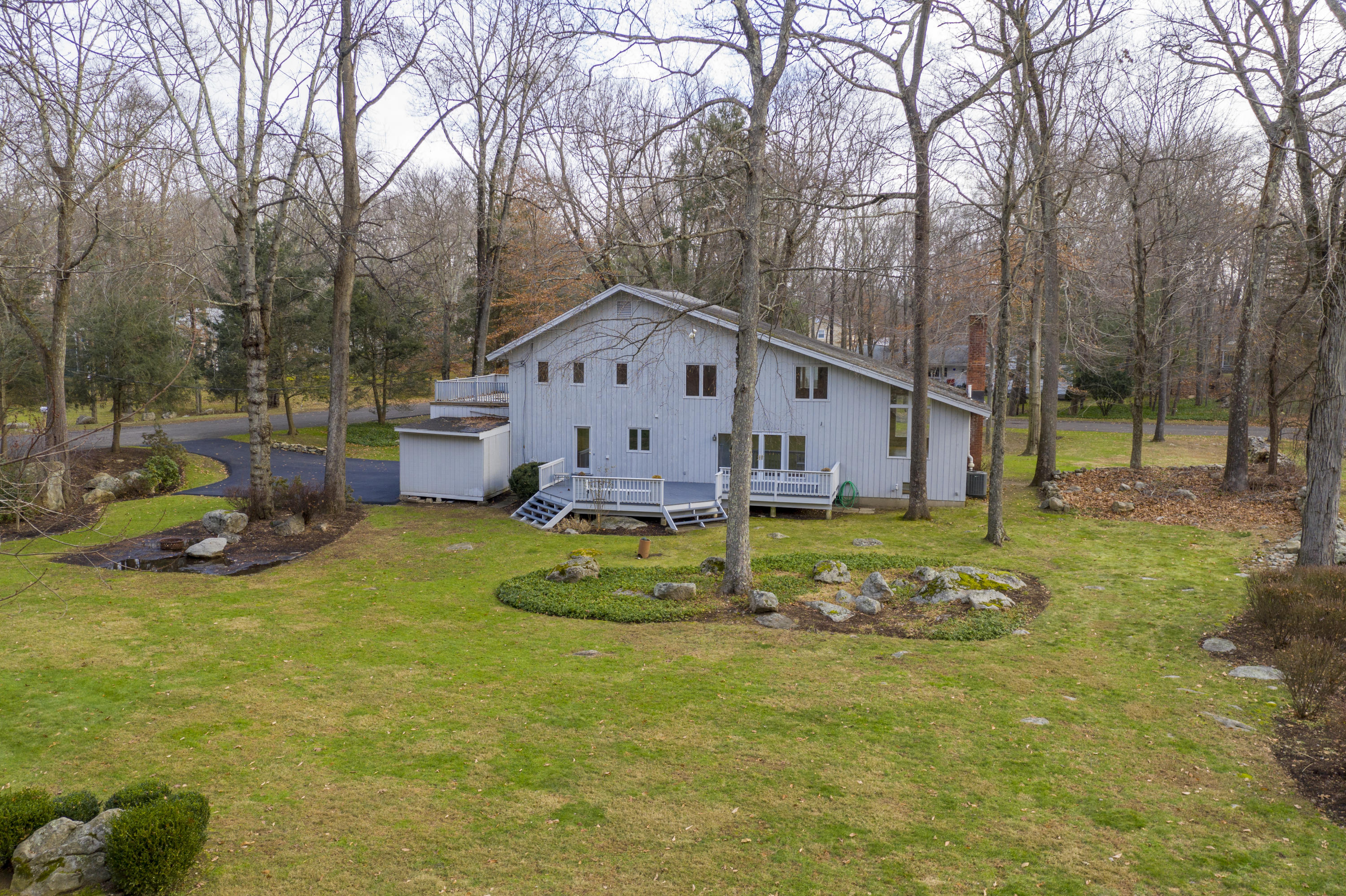 92 Rolling Ridge Road Stamford, CT 06903 - Photo 29 of 34 a view of a house with a yard