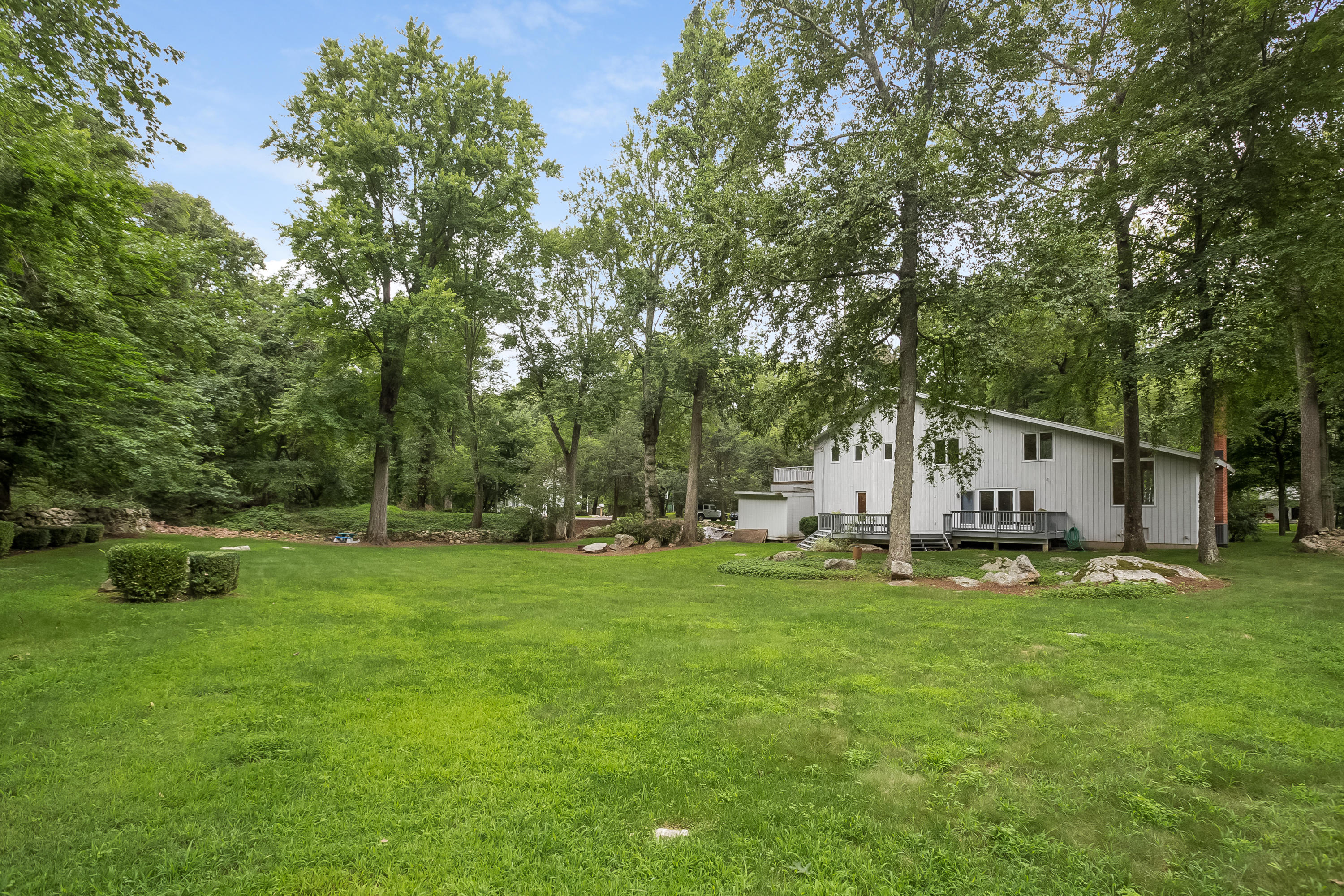 92 Rolling Ridge Road Stamford, CT 06903 - Photo 30 of 34 a white house that has a big yard