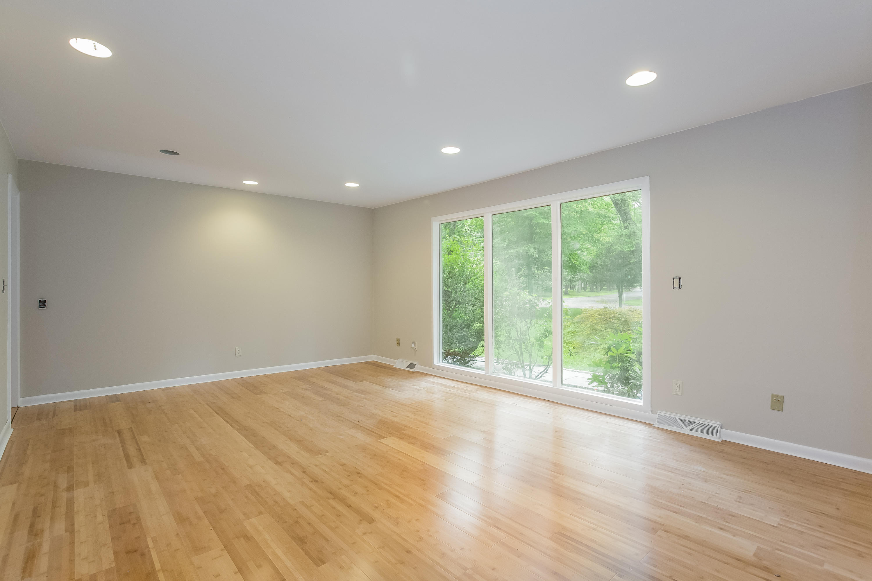 92 Rolling Ridge Road Stamford, CT 06903 - Photo 7 of 34 a view of an empty room with wooden floor and a window