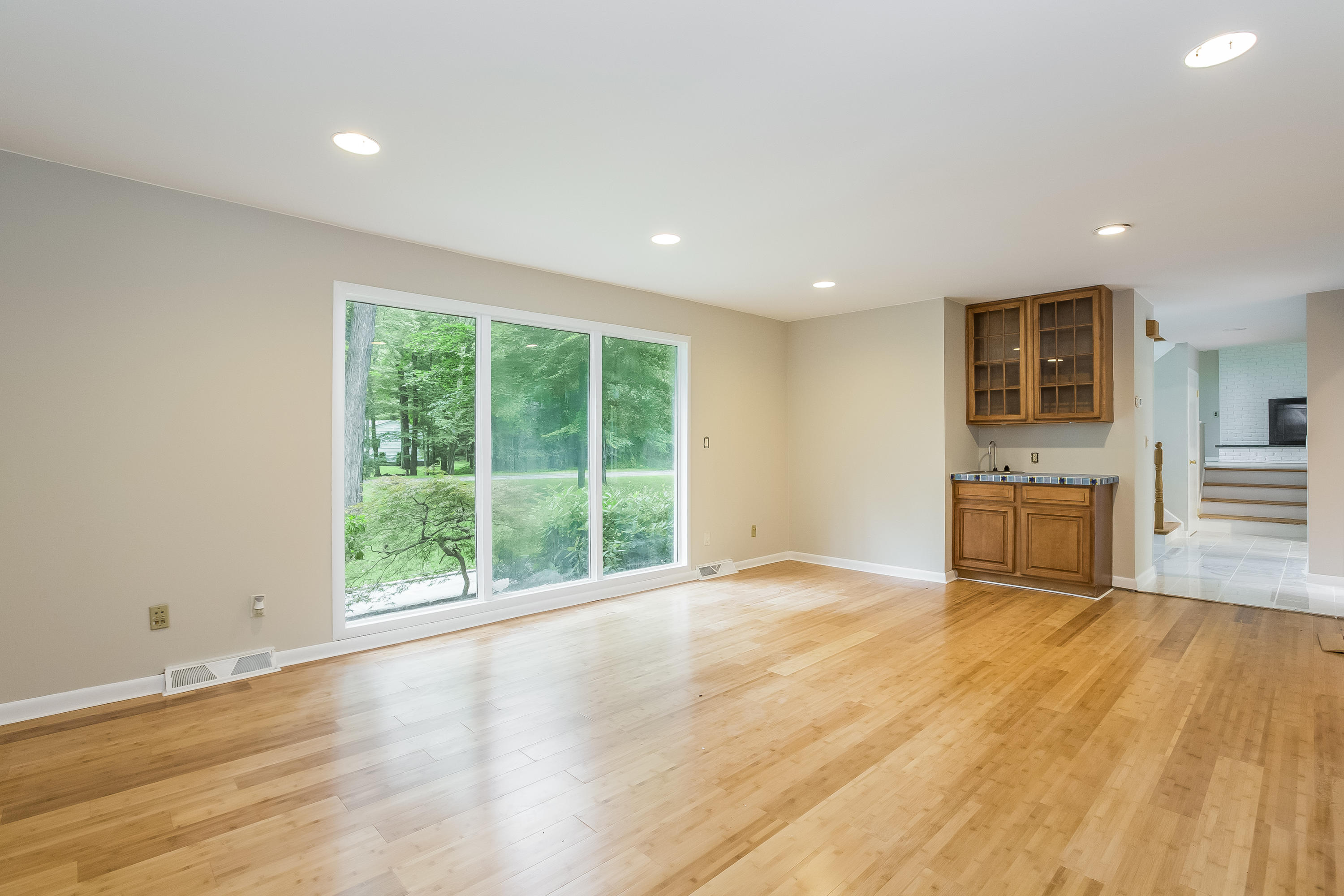 92 Rolling Ridge Road Stamford, CT 06903 - Photo 8 of 34 a view of an empty room with wooden floor and a window