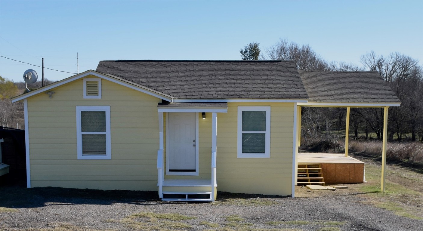 View of front facade featuring a shingled roof
