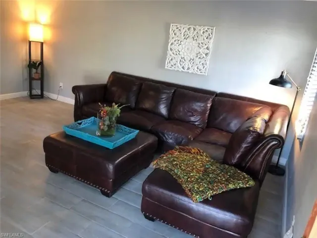 a living room with furniture and a lamp