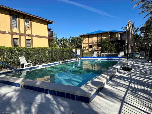 swimming pool view with a garden