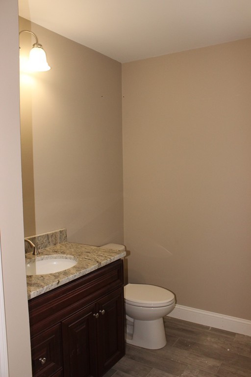 179 Groton Road Chelmsford, MA 01863 - Photo 11 of 19 a bathroom with a granite countertop toilet and a sink