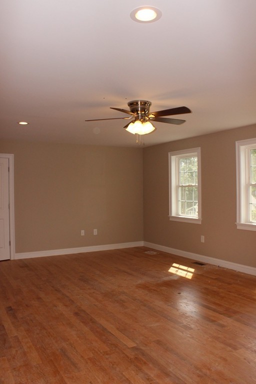 179 Groton Road Chelmsford, MA 01863 - Photo 13 of 19 an empty room with wooden floor and windows