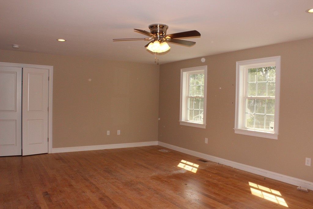 179 Groton Road Chelmsford, MA 01863 - Photo 14 of 19 a view of an empty room with wooden floor and a window