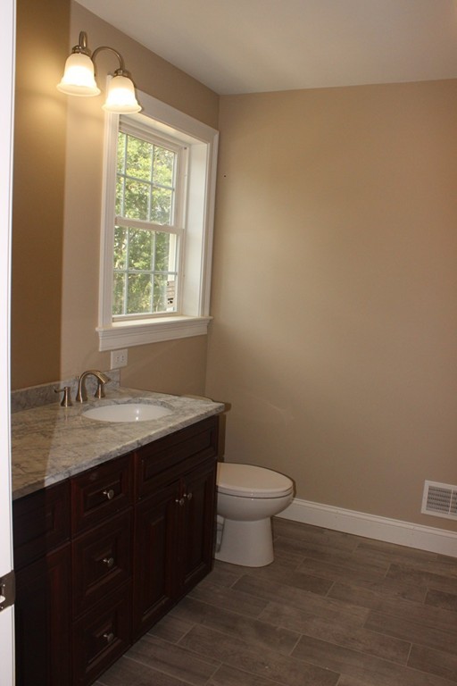 179 Groton Road Chelmsford, MA 01863 - Photo 15 of 19 a bathroom with a granite countertop sink toilet and mirror