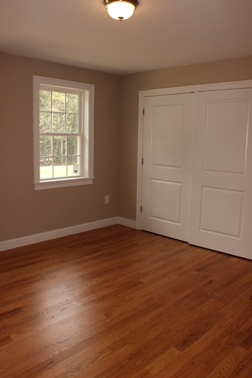 179 Groton Road Chelmsford, MA 01863 - Photo 17 of 19 a view of an empty room with wooden floor and a window