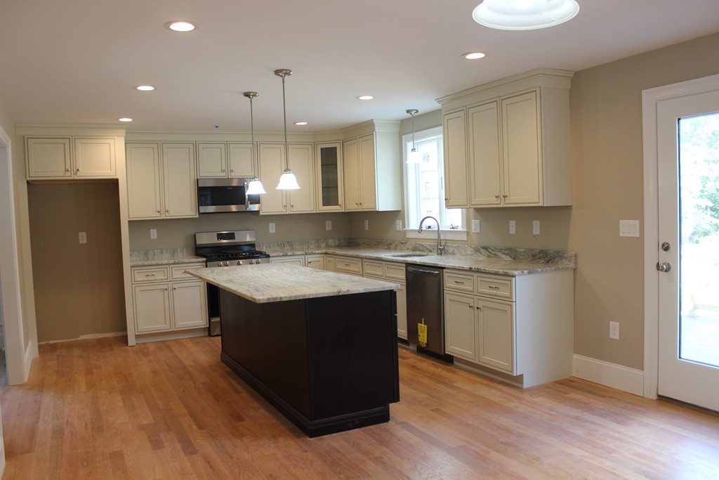 179 Groton Road Chelmsford, MA 01863 - Photo 3 of 19 a kitchen with kitchen island granite countertop a sink cabinets and stainless steel appliances