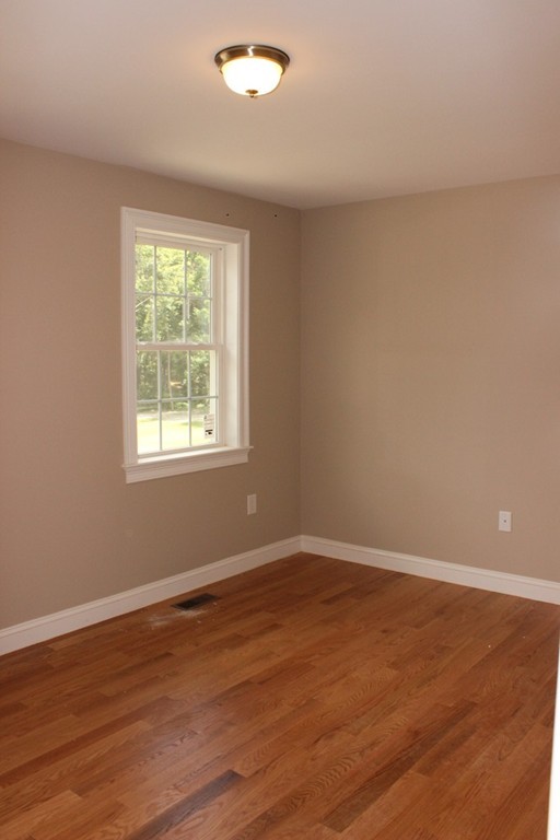 179 Groton Road Chelmsford, MA 01863 - Photo 10 of 19 an empty room with wooden floor and windows