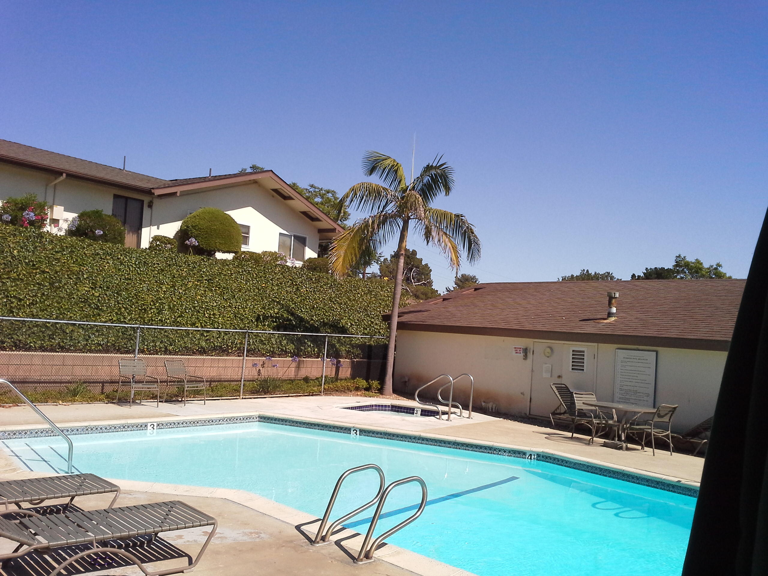 817 Cieneguitas Road Santa Barbara, CA 93110 - Photo 3 of 12 a view of a swimming pool with a table and chairs under an umbrella