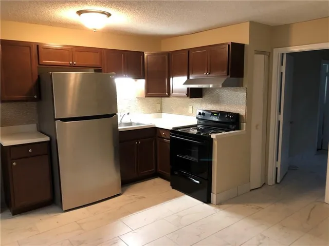 a kitchen with a refrigerator stove and microwave