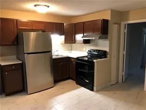 a kitchen with a refrigerator stove and microwave