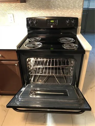 a stove top oven sitting inside of a kitchen