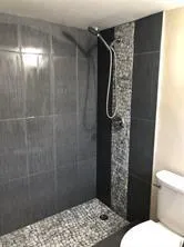 a bathroom with a shower toilet and sink