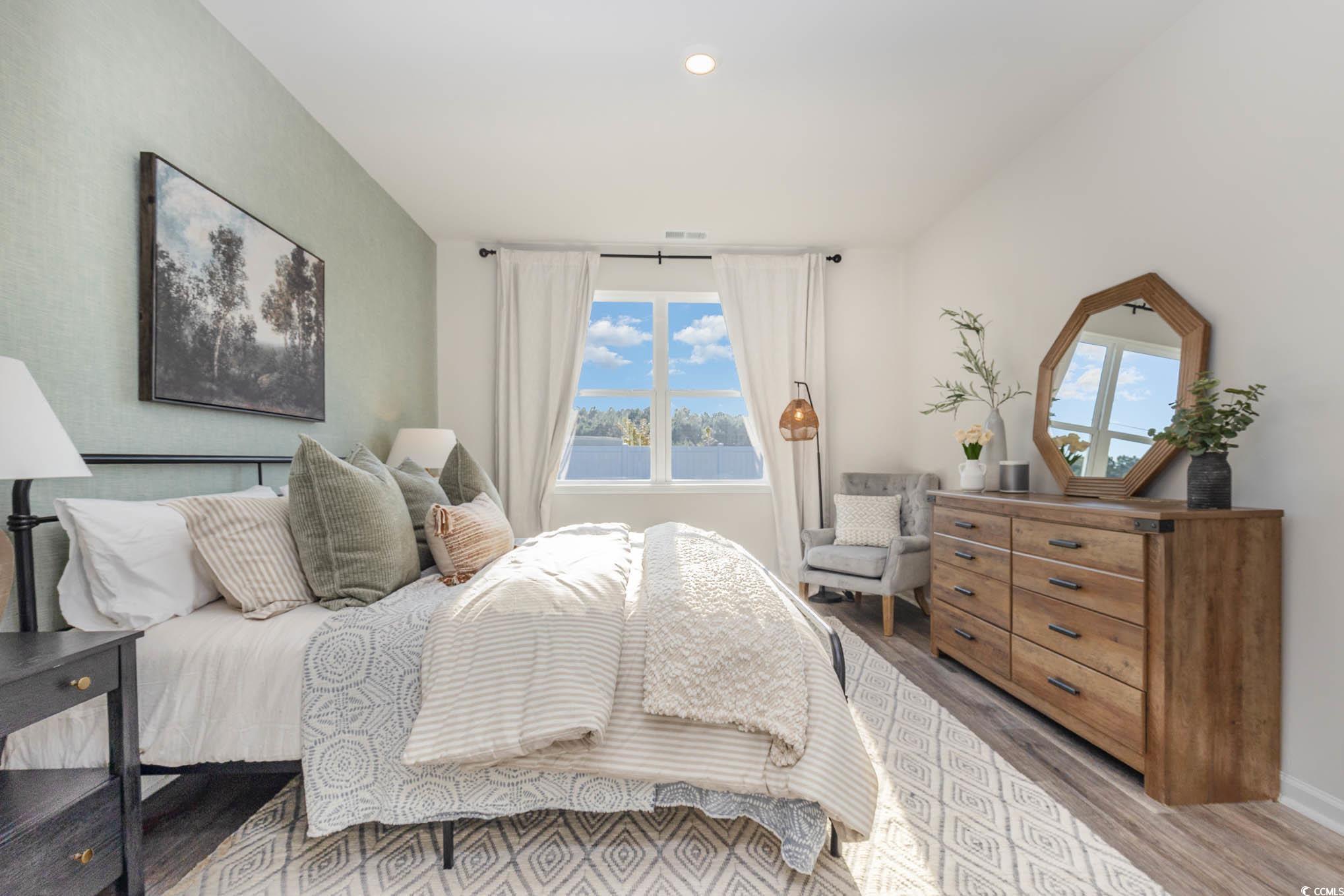 573 Duvall Street Longs, SC 29568 - Photo 4 of 14 Bedroom with hardwood / wood-style flooring and multiple windows