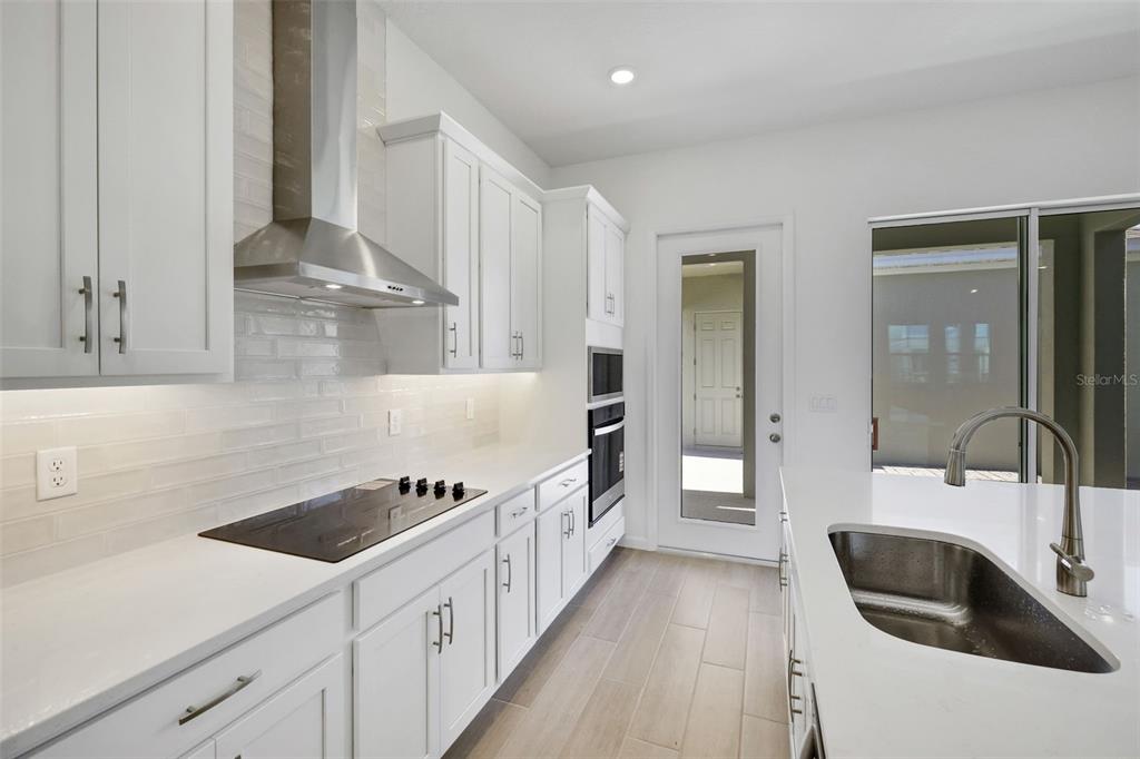 13037 Serene Glade Road Winter Garden, FL 34787 - Photo 13 of 62 a kitchen with granite countertop a sink and cabinets