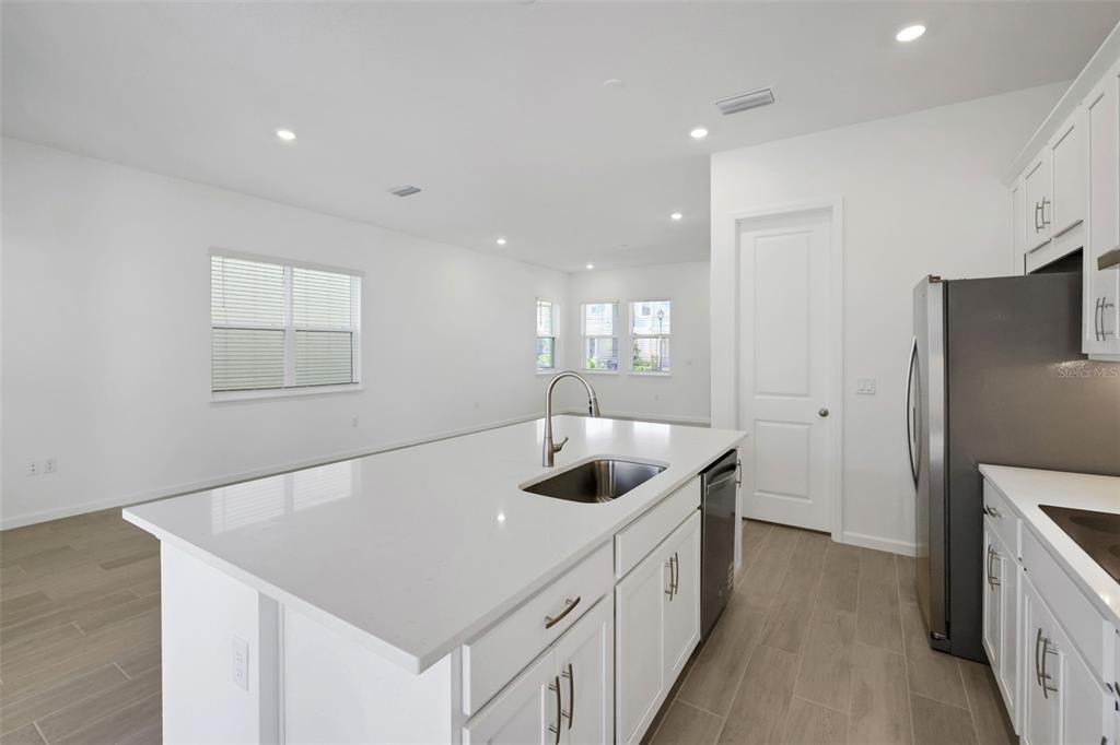 13037 Serene Glade Road Winter Garden, FL 34787 - Photo 14 of 62 a kitchen with stainless steel appliances granite countertop a sink and a refrigerator