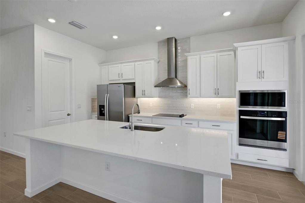 13037 Serene Glade Road Winter Garden, FL 34787 - Photo 15 of 62 a kitchen with refrigerator and cabinets