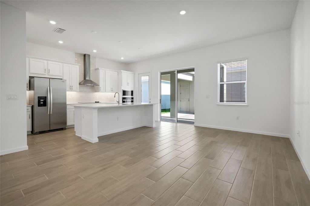 13037 Serene Glade Road Winter Garden, FL 34787 - Photo 21 of 62 a view of a kitchen with a sink and dishwasher a refrigerator with wooden floor
