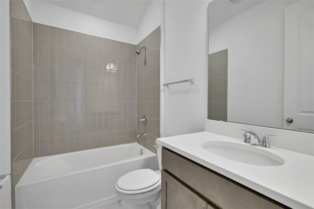 13037 Serene Glade Road Winter Garden, FL 34787 - Photo 29 of 62 a bathroom with a granite countertop sink toilet tub and shower