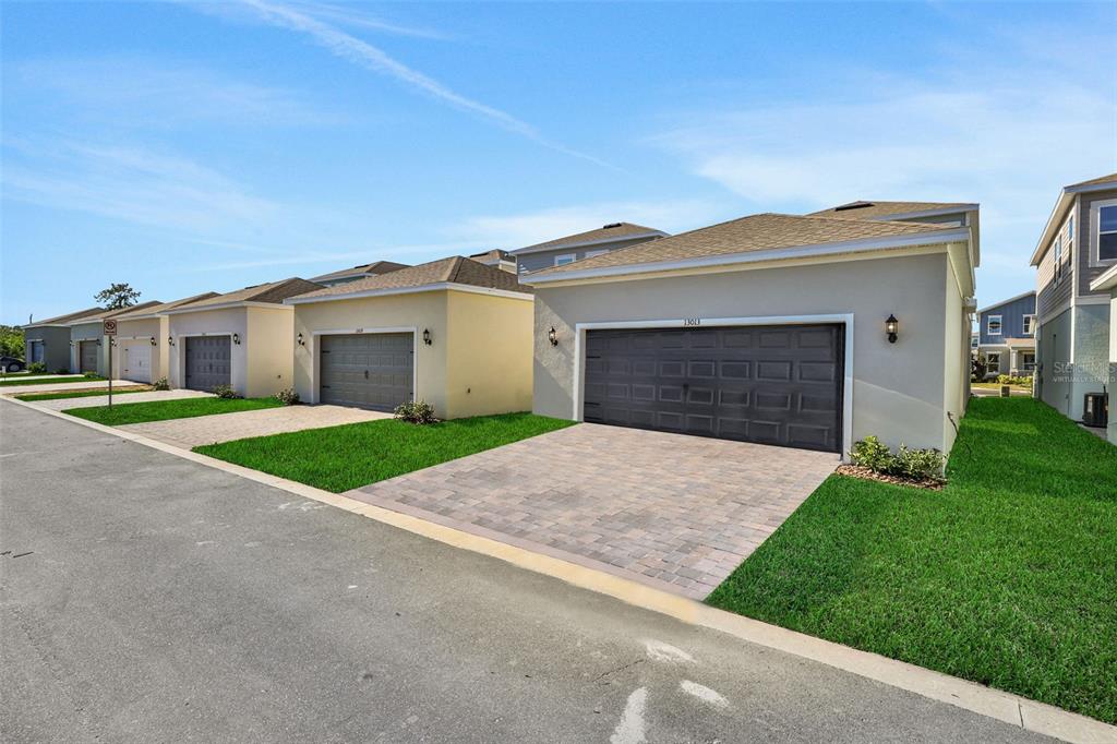 13037 Serene Glade Road Winter Garden, FL 34787 - Photo 34 of 62 a front view of house with yard and garage
